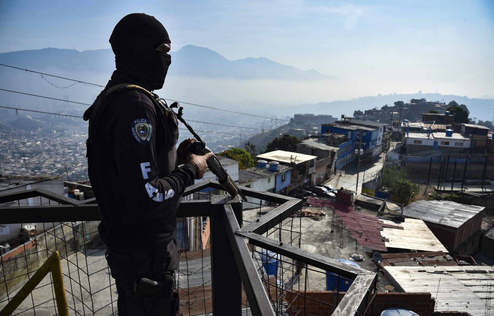 Un funcionario de las FAES monta guardia en las alturas de un barrio en Caracas en el 2019 | AFP